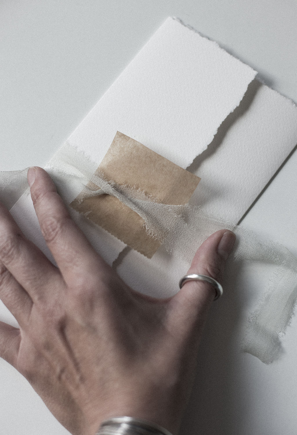 Sealing a wedding invitation with silk ribbon and a way seal.